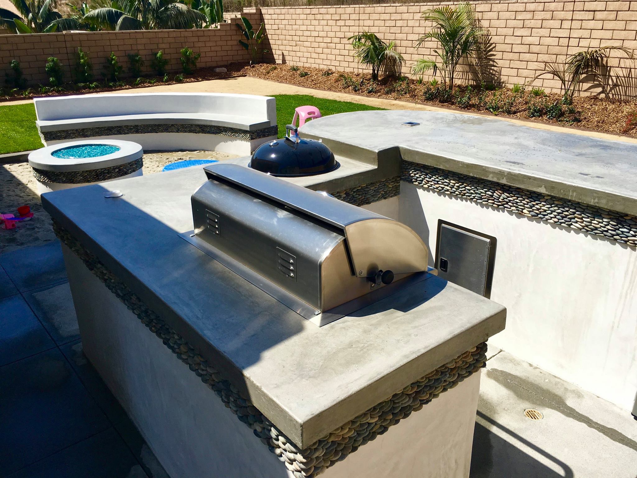 Custom fire pit and BBQ island installation by Arcadian Landscape in San Diego