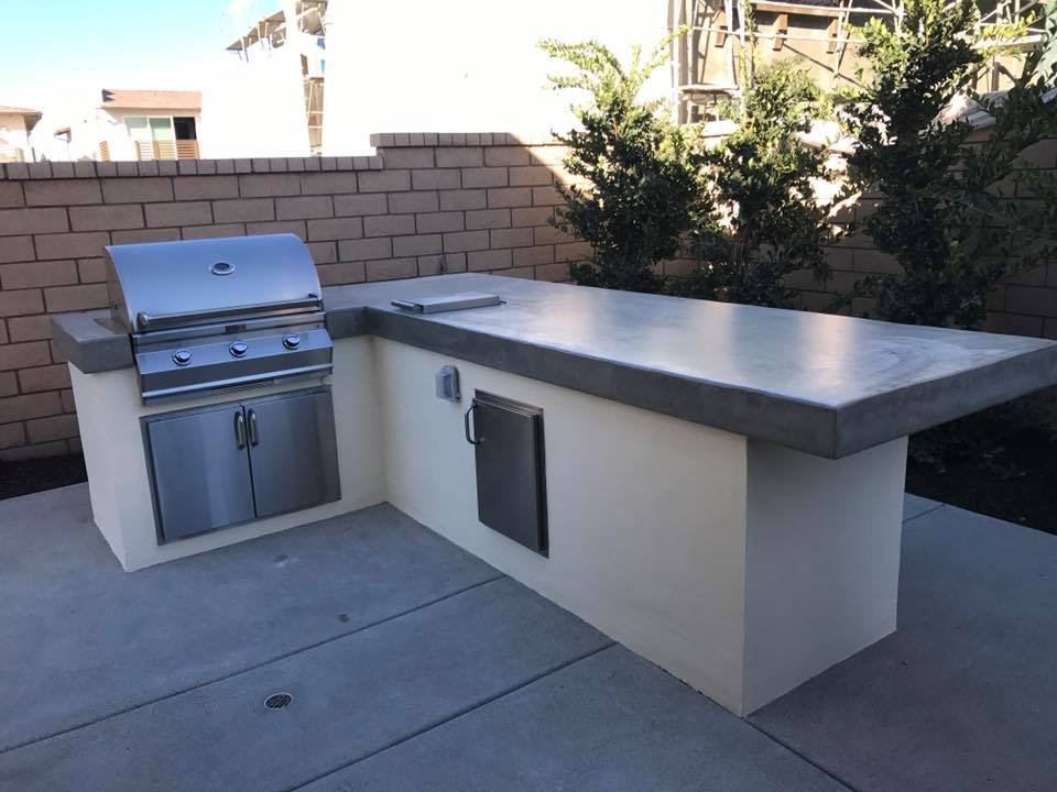 Custom outdoor kitchen and BBQ island with stone countertops