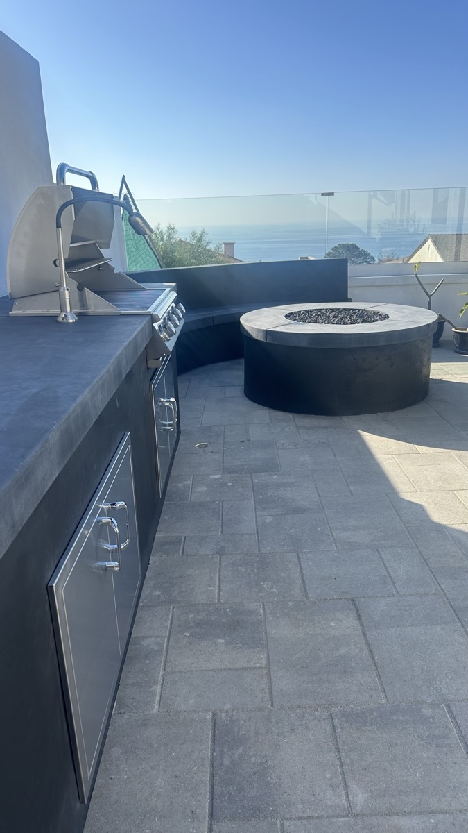 Custom fire pit and outdoor kitchen with ocean view in San Diego