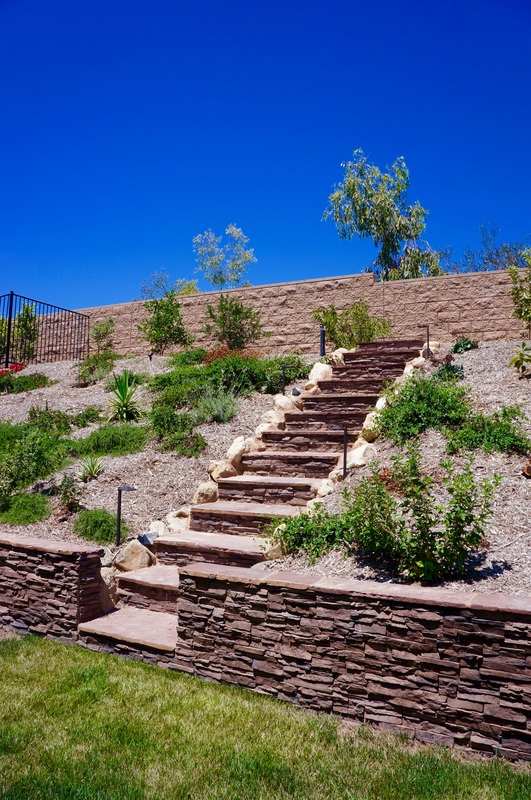 Outdoor living space with layered lighting across multiple zones