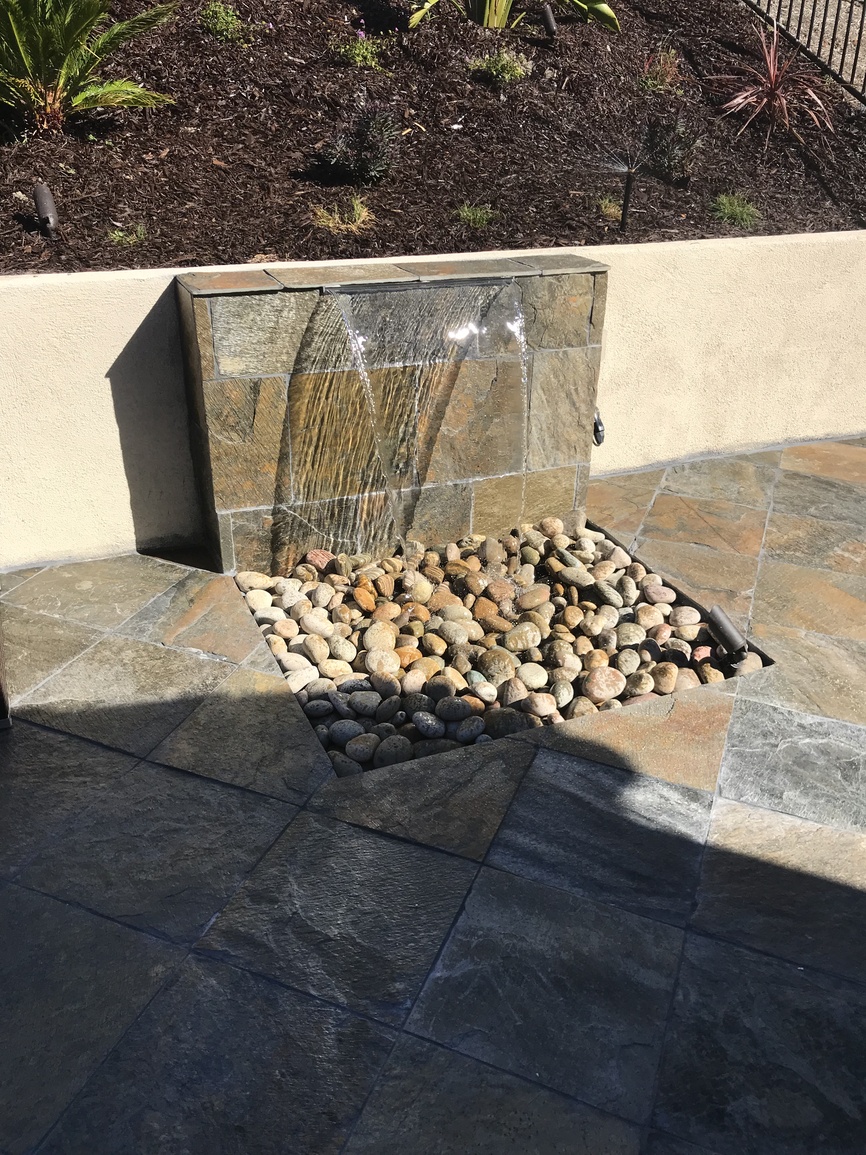 Curated outdoor space with native plantings and stone accents