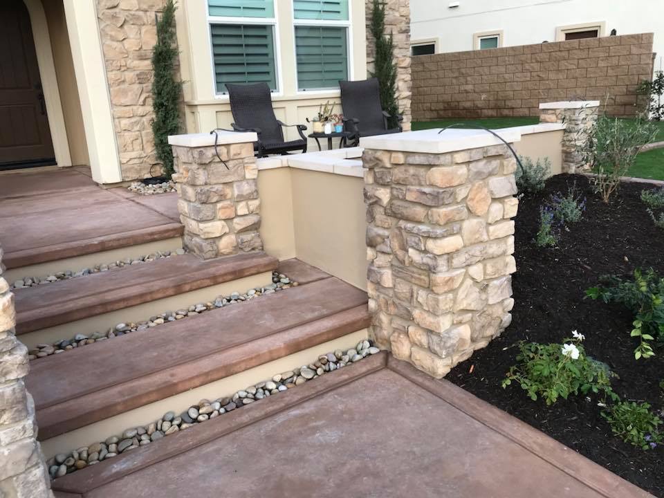 BBQ island mid-construction with stone veneer