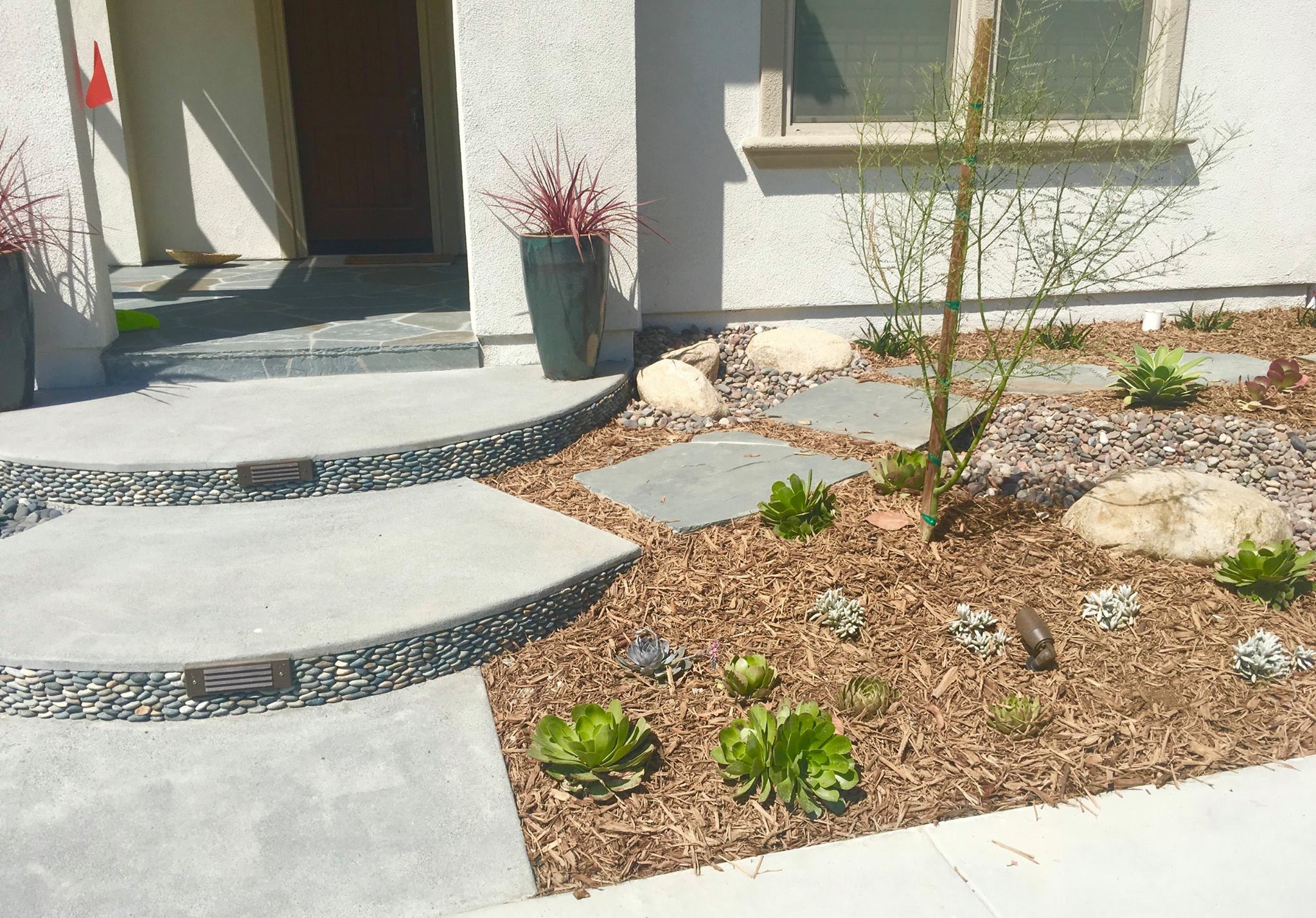 Modern hardscape patio with pavers and fire pit in San Diego